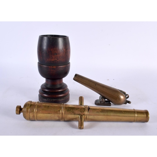 458 - TWO ANTIQUE BRONZE CANNONS together with a treen mortar. Largest 16 cm high. (3)