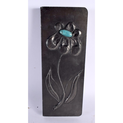 464 - A VINTAGE PEWTER AND TURQUOISE STONE BOOK COVER decorated with a flower. 28cm x 10 cm.