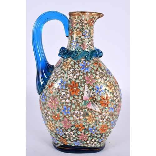 47 - AN ART NOUVEAU ENAMELLED BLUE GLASS AESTHETIC JUG decorated in relief with birds amongst foliage. 19... 