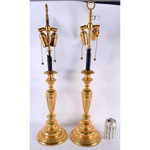 488 - A LARGE PAIR OF CONTINENTAL GILT METAL CANDLESTICKS. 66 cm long.