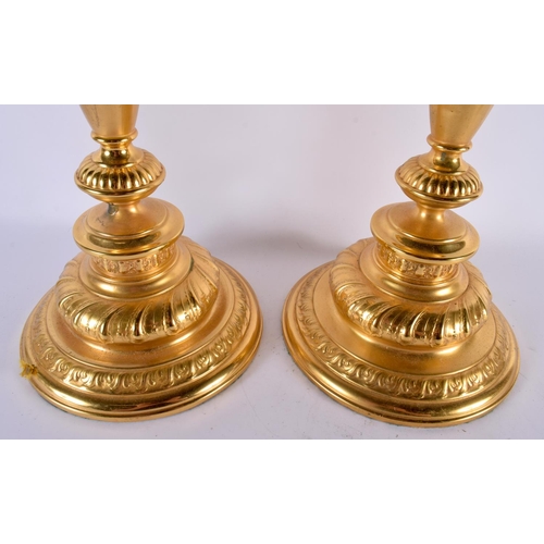 488 - A LARGE PAIR OF CONTINENTAL GILT METAL CANDLESTICKS. 66 cm long.