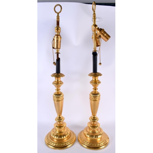 488 - A LARGE PAIR OF CONTINENTAL GILT METAL CANDLESTICKS. 66 cm long.