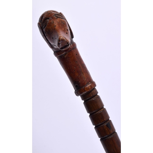 492 - AN ANTIQUE FOLK ART DOG HEAD CARVED WOOD SWAGGER STICK. 83 cm long.