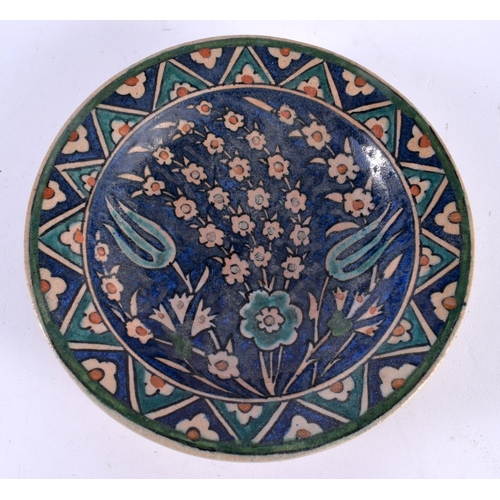 493 - A MIDDLE EASTERN FAIENCE IZNIK TYPE POTTERY BOWL. 18cm diameter.