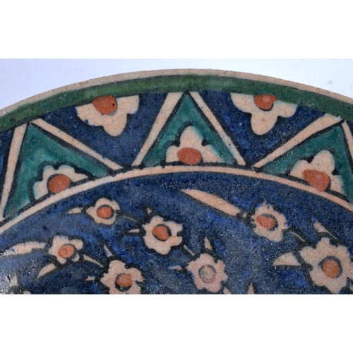 493 - A MIDDLE EASTERN FAIENCE IZNIK TYPE POTTERY BOWL. 18cm diameter.