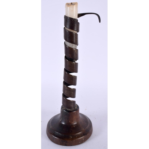 497 - AN ANTIQUE PIG TWIST TREEN CANDLESTICK. 24 cm high.