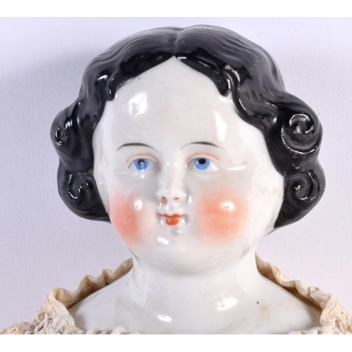 499 - AN ANTIQUE PORCELAIN HEADED DOLL with lace outfit. 38 cm long.