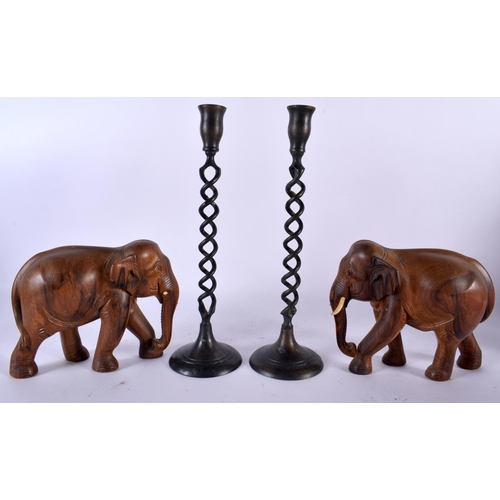 501 - A PAIR OF ANGLO INDIAN CARVED HARDWOOD FIGURES OF ELEPHANTS together with a pair of spiral twist pat... 