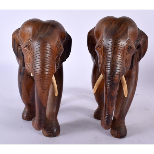 501 - A PAIR OF ANGLO INDIAN CARVED HARDWOOD FIGURES OF ELEPHANTS together with a pair of spiral twist pat... 