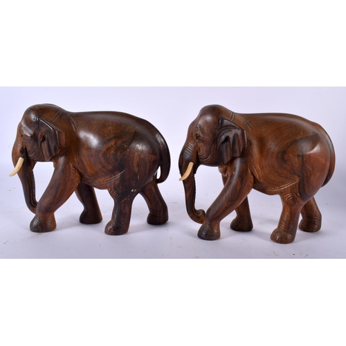 501 - A PAIR OF ANGLO INDIAN CARVED HARDWOOD FIGURES OF ELEPHANTS together with a pair of spiral twist pat... 