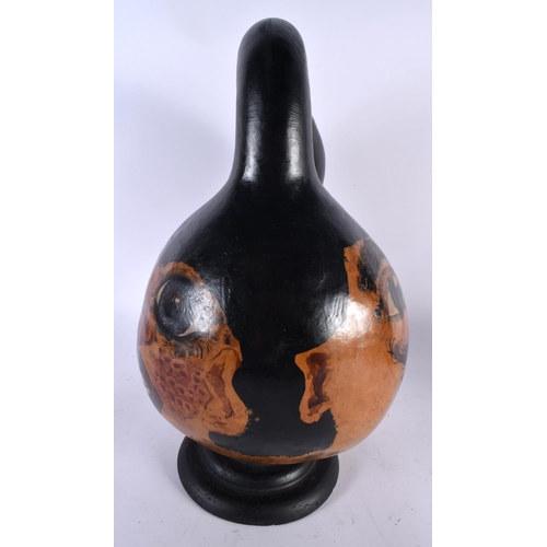 503 - AN UNUSUAL MIDDLE EASTERN PAINTED BIZARRE FORM GOURD NUT depicting a portrait. 36 cm high.