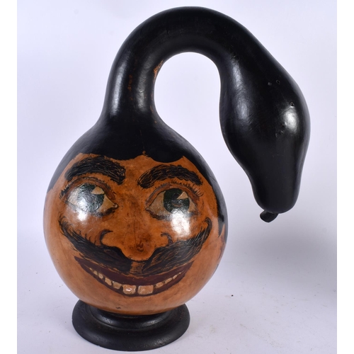 503 - AN UNUSUAL MIDDLE EASTERN PAINTED BIZARRE FORM GOURD NUT depicting a portrait. 36 cm high.