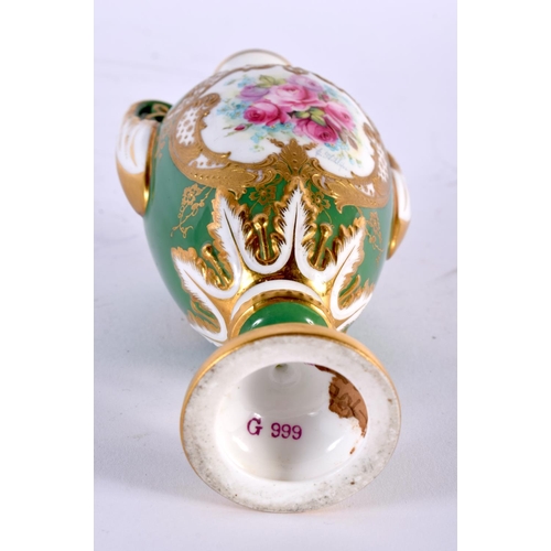 5 - A FINE ANTIQUE ROYAL WORCESTER TWIN HANDLED PORCELAIN VASE by E Phillips, painted with roses upon an... 