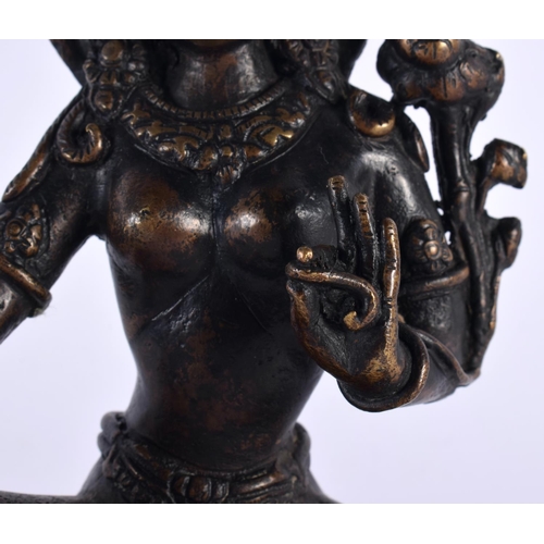 506 - A 19TH CENTURY INDIAN NEPALESE BRONZE FIGURE OF A SEATED BUDDHA modelled with one hand raised. 18cm ... 