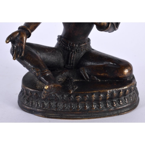 506 - A 19TH CENTURY INDIAN NEPALESE BRONZE FIGURE OF A SEATED BUDDHA modelled with one hand raised. 18cm ... 