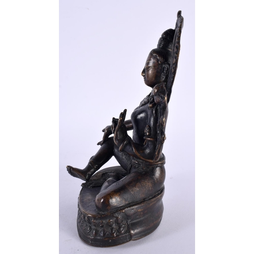 506 - A 19TH CENTURY INDIAN NEPALESE BRONZE FIGURE OF A SEATED BUDDHA modelled with one hand raised. 18cm ... 