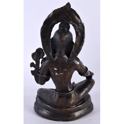 506 - A 19TH CENTURY INDIAN NEPALESE BRONZE FIGURE OF A SEATED BUDDHA modelled with one hand raised. 18cm ... 