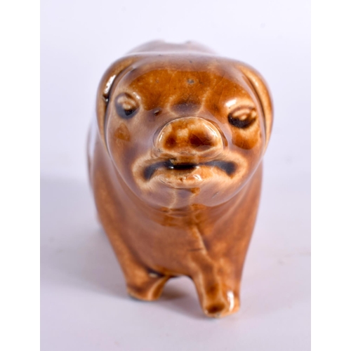 51 - A SMALL TREACLE GLAZED PIG POTTERY MONEY BOX. 13 cm x 8 cm.