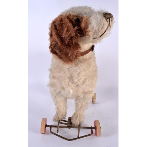 516 - AN ANTIQUE PULL ALONG STRAW FILLED DOG TOY. 36 cm x 36 cm.