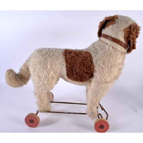 516 - AN ANTIQUE PULL ALONG STRAW FILLED DOG TOY. 36 cm x 36 cm.