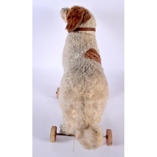 516 - AN ANTIQUE PULL ALONG STRAW FILLED DOG TOY. 36 cm x 36 cm.