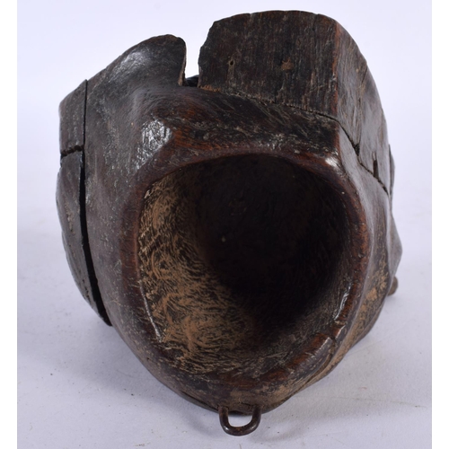 528 - A 19TH CENTURY CARVED WOOD TREEN SPILL HOLDER formed as a mask head. 13 cm x 9 cm.