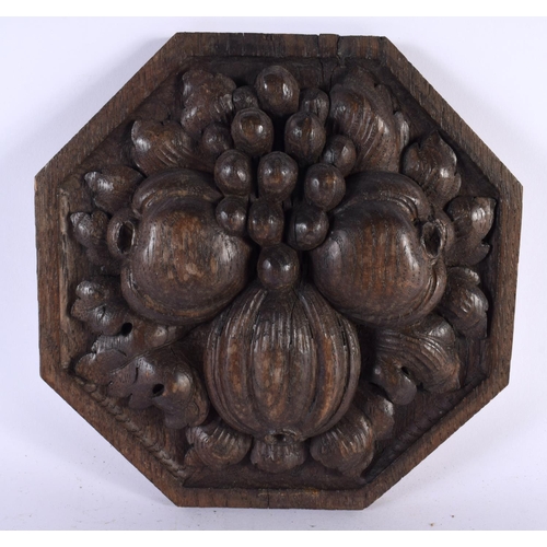 539 - AN ARTS AND CRAFTS CARVED OAK FRUITING POD PLAQUE. 20cm wide.