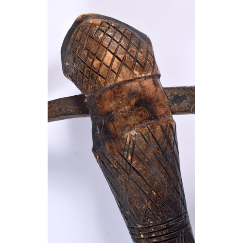 546 - AN AFRICAN TRIBAL CARVED WOOD AND IRON AXE together with two others. Largest 52 cm long. (3)