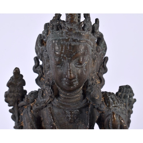 551 - A 19TH CENTURY INDIAN NEPALESE BRONZE FIGURE OF A SEATED BUDDHA modelled upon a triangular base. 13 ... 