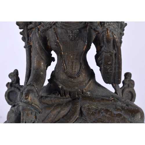 551 - A 19TH CENTURY INDIAN NEPALESE BRONZE FIGURE OF A SEATED BUDDHA modelled upon a triangular base. 13 ... 