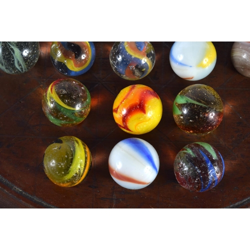 559 - A SOLITAIRE MARBLE BOARD with marbles. 20cm diameter. (qty)