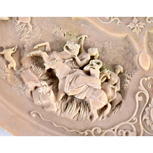 574 - A RARE EARLY 20TH CENTURY EUROPEAN LAVA STONE CARVED DISH depicting classical scenes. 20cm diameter.