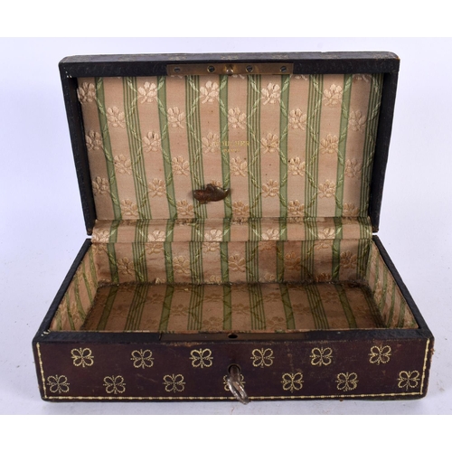 579 - A VINTAGE LEATHER JEWELLERY BOX. 15cm x 12 cm.