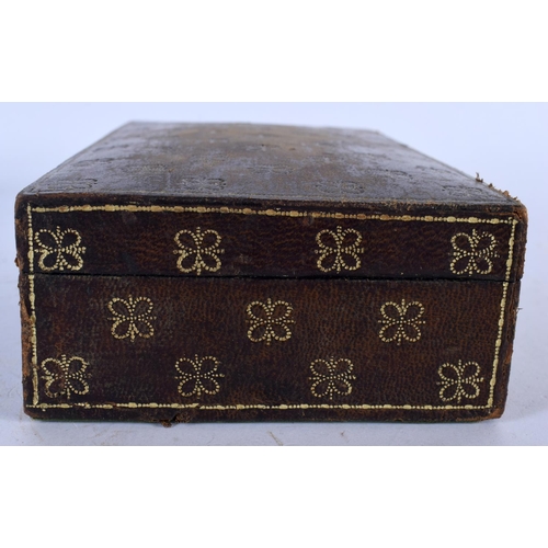 579 - A VINTAGE LEATHER JEWELLERY BOX. 15cm x 12 cm.