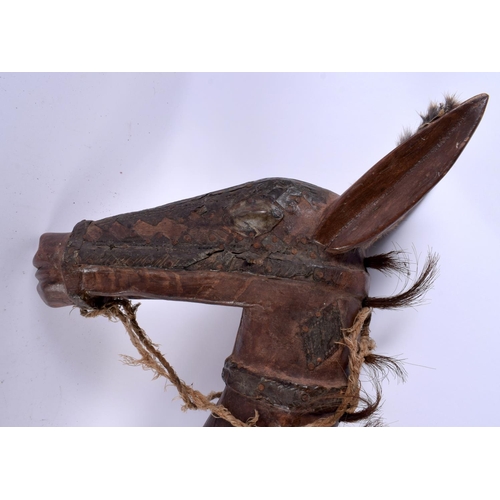 581 - AN UNUSUAL EARLY 20TH CENTURY CARVED CONTINENTAL HORSE STICK possibly a toy. 85 cm long.