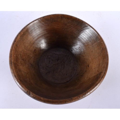 582 - A TREEN BUTTER BOWL with spoon. Largest 24 cm diameter. (2)