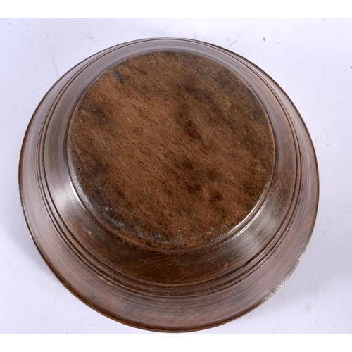 582 - A TREEN BUTTER BOWL with spoon. Largest 24 cm diameter. (2)