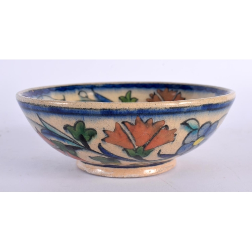 60 - A MIDDLE EASTERN FAIENCE IZNIK TYPE POTTERY DISH painted with flowers. 12 cm diameter.