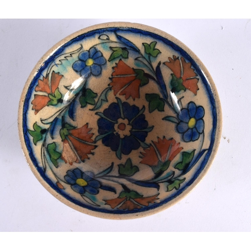 60 - A MIDDLE EASTERN FAIENCE IZNIK TYPE POTTERY DISH painted with flowers. 12 cm diameter.