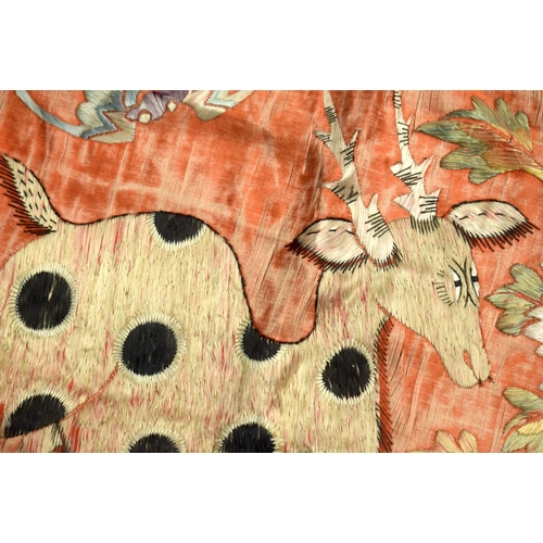 602 - A 19TH CENTURY CHINESE ORANGE SILK EMBROIDERED PANEL depicting a spotted deer within a landscape. 94... 