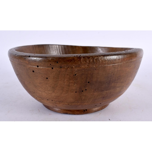 603 - AN ANTIQUE TREEN BUTTER BOWL. 15cm diameter.