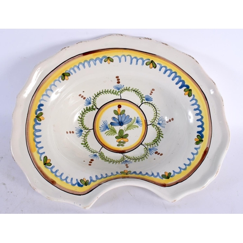 61 - AN ANTIQUE FRENCH FAIENCE TIN GLAZED POTTERY BARBERS BOWL painted with flowers. 27 cm x 22cm.