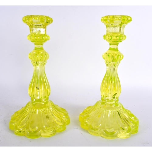 63 - A PAIR OF ART DECO URANIUM GLASS CANDLESTICKS. 24 cm high.