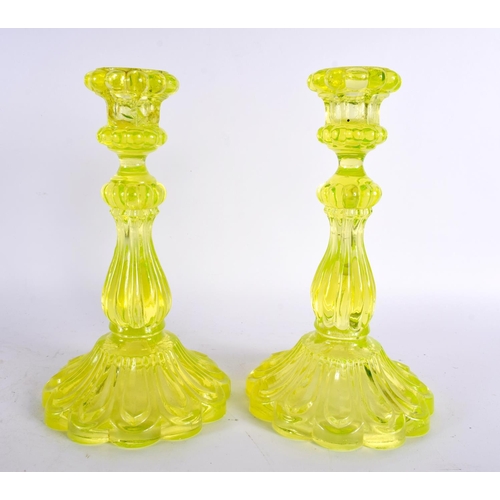 63 - A PAIR OF ART DECO URANIUM GLASS CANDLESTICKS. 24 cm high.