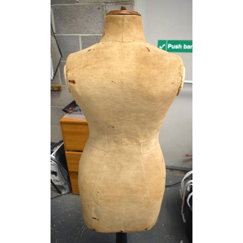 653 - AN EARLY 20TH CENTURY DRESSMAKERS MANNEQUIN on an ebonised tripod base. 135 cm x 30cm.