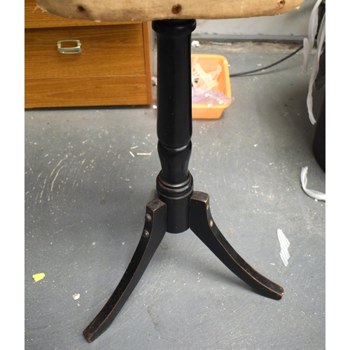 653 - AN EARLY 20TH CENTURY DRESSMAKERS MANNEQUIN on an ebonised tripod base. 135 cm x 30cm.