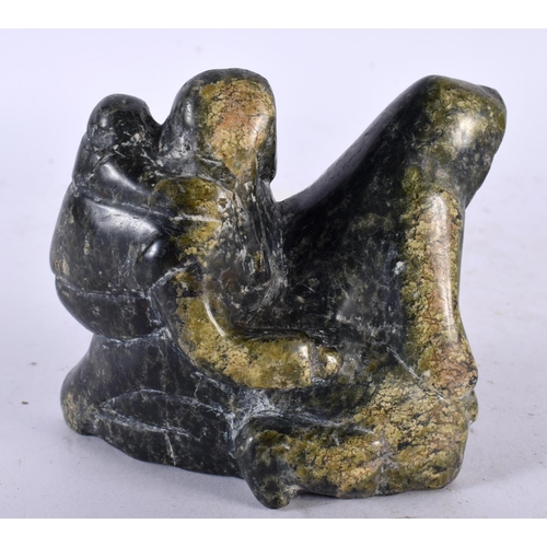 659 - A NORTH AMERICAN INUIT TRIBAL CARVED STONE FIGURE OF A FAMILY. 9 cm x 8 cm.