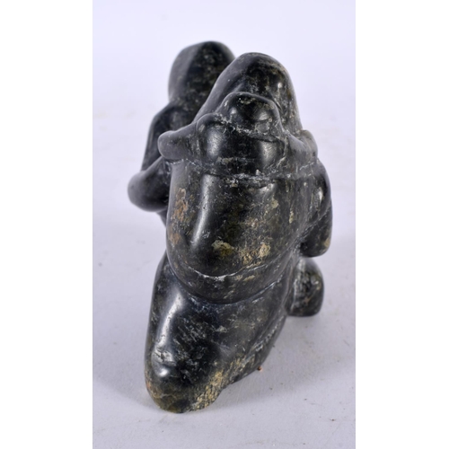 659 - A NORTH AMERICAN INUIT TRIBAL CARVED STONE FIGURE OF A FAMILY. 9 cm x 8 cm.