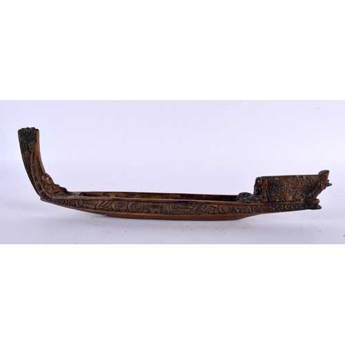 664 - A NEW ZEALAND TRIBAL WAKA TAUA WAR CANOE by Allan Davey & Company. 34 cm long.