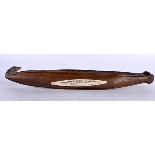 664 - A NEW ZEALAND TRIBAL WAKA TAUA WAR CANOE by Allan Davey & Company. 34 cm long.